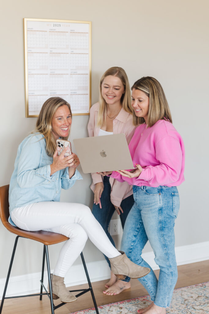 three women business integrators looking at a computer