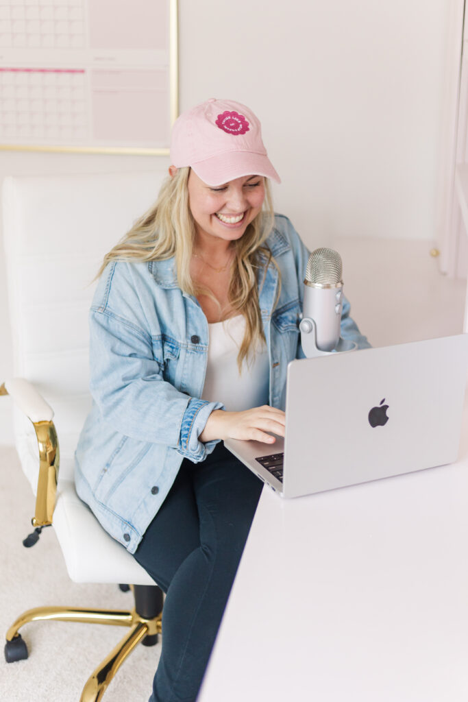 woman webinar host sitting at a microphone and computer