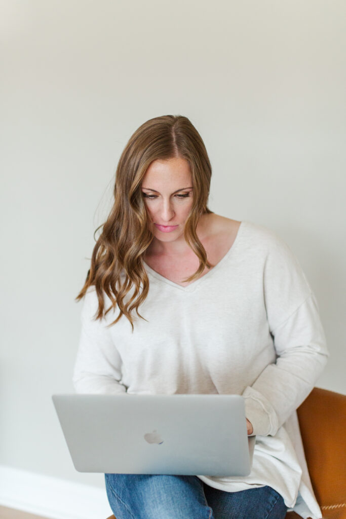 woman looking down at a computer