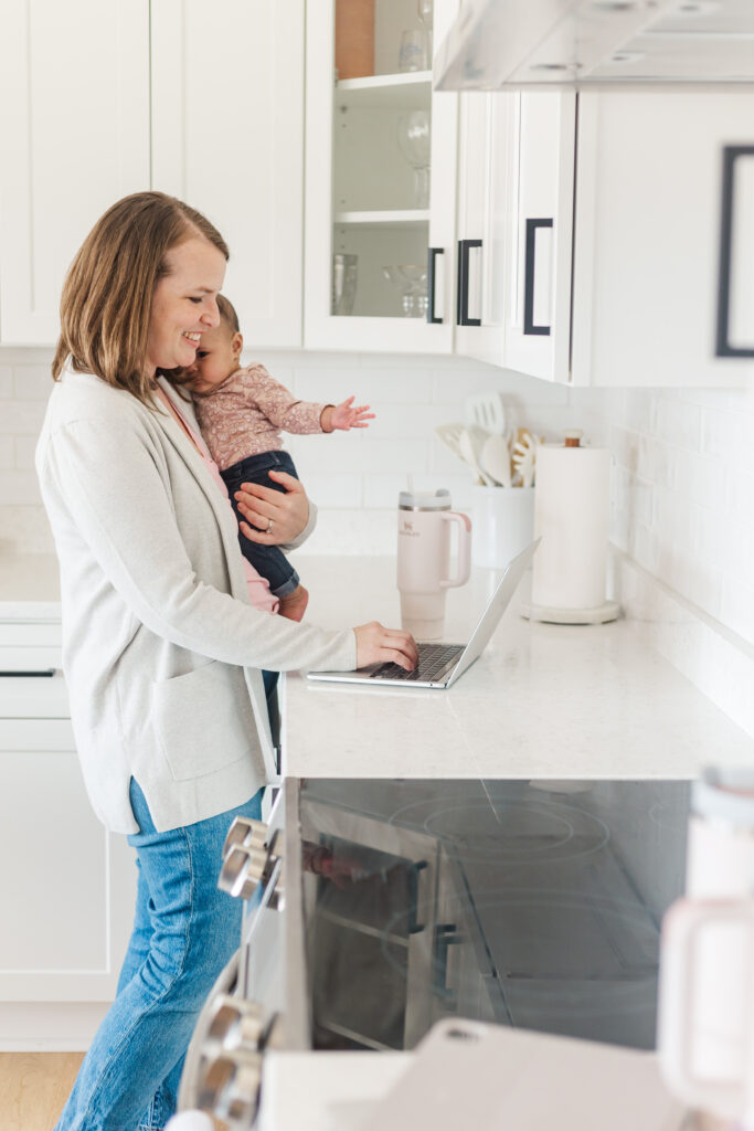 woman integrator at a computer holding a baby