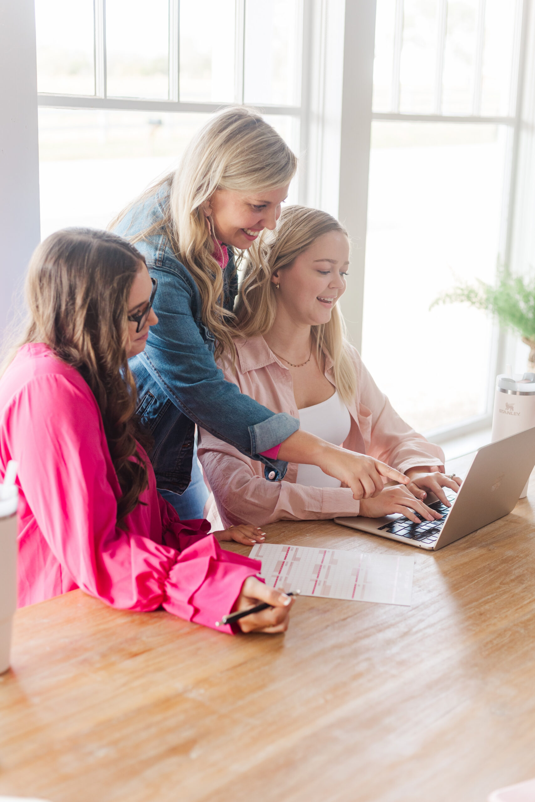 three women integrators looking at a computer