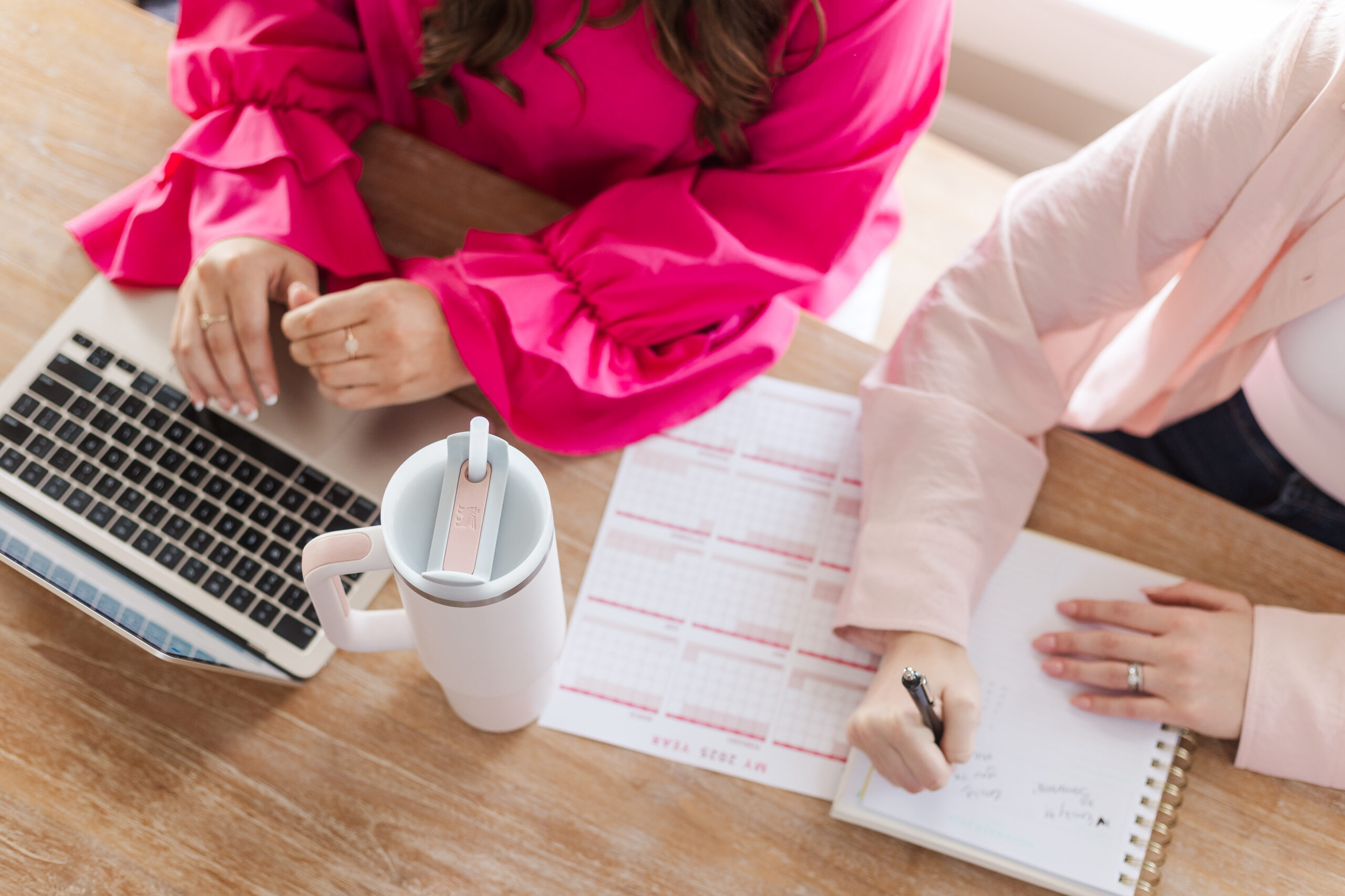 two women integrators at a computer taking notes